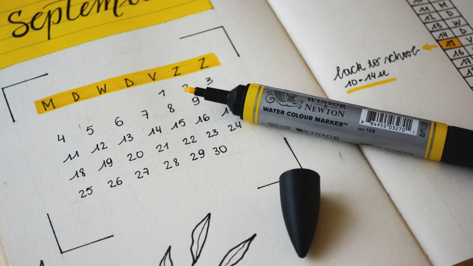 A monthly calendar in a planner with a marker, for planning and scheduling